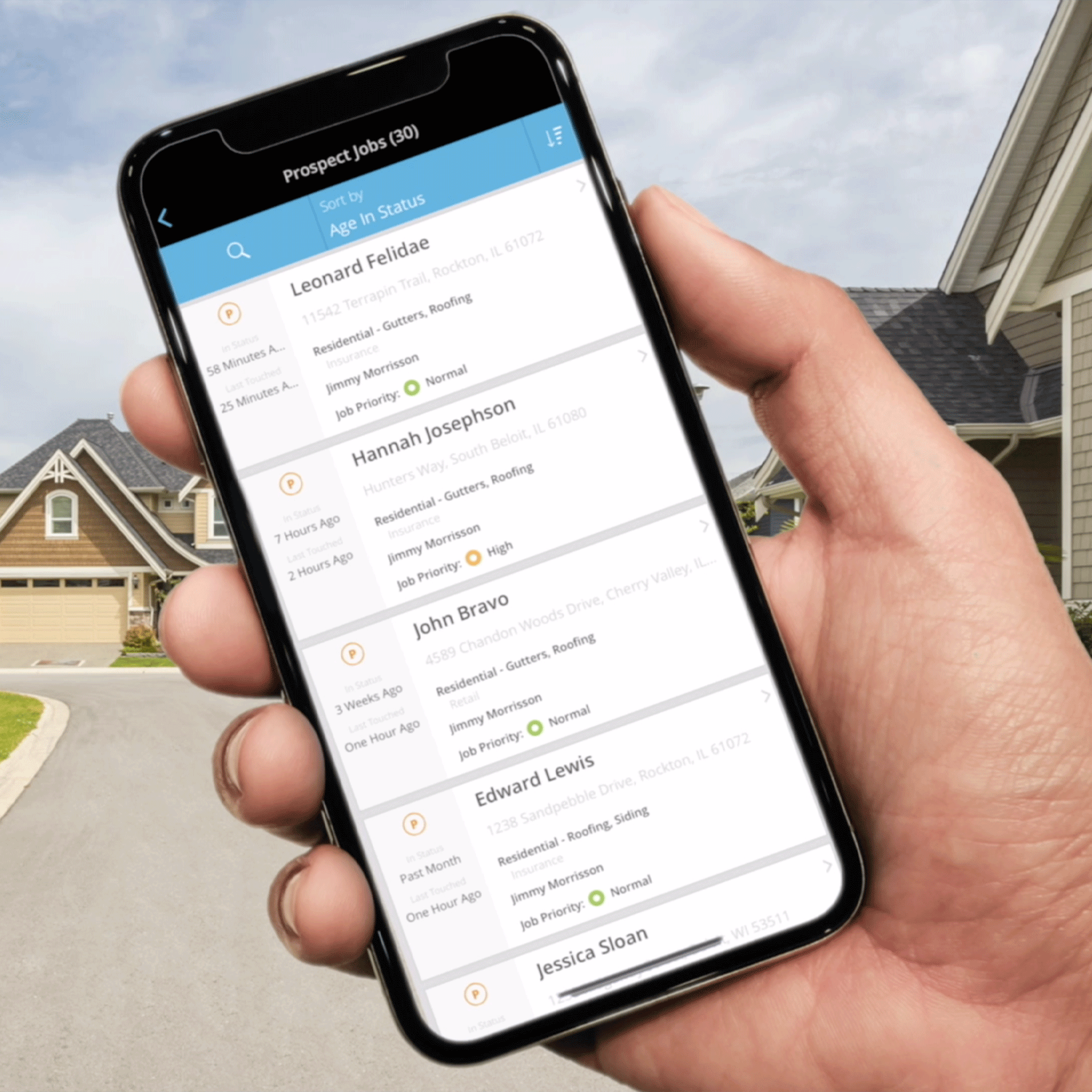hand holding mobile phone with Acculynx ui displayed