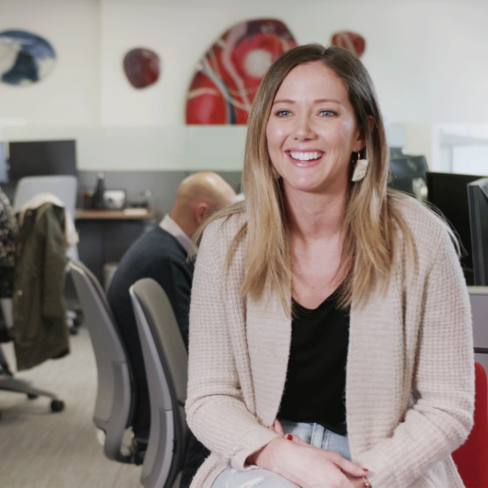 Smiling employee talking with Savage Media about how the artwork installed at First Person makes the office a better place to work. 